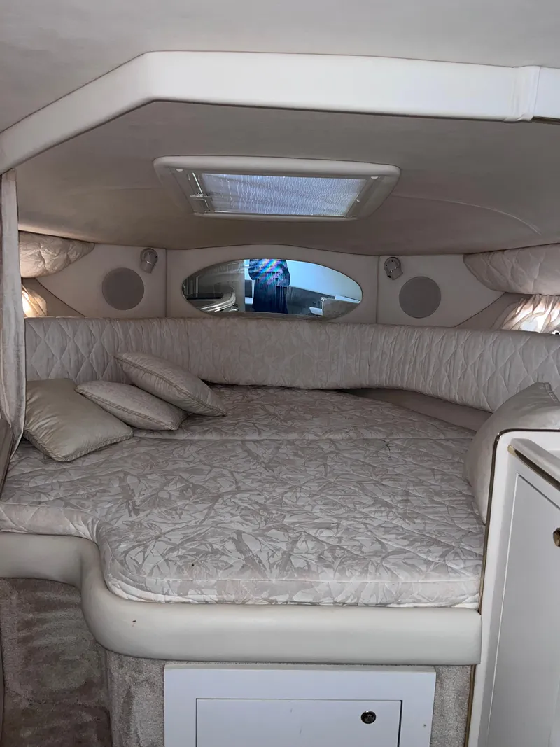 Slide: The Image of Interior cabin of 2000 Sea Ray 290 Amberjack with bed and cushions. - 19