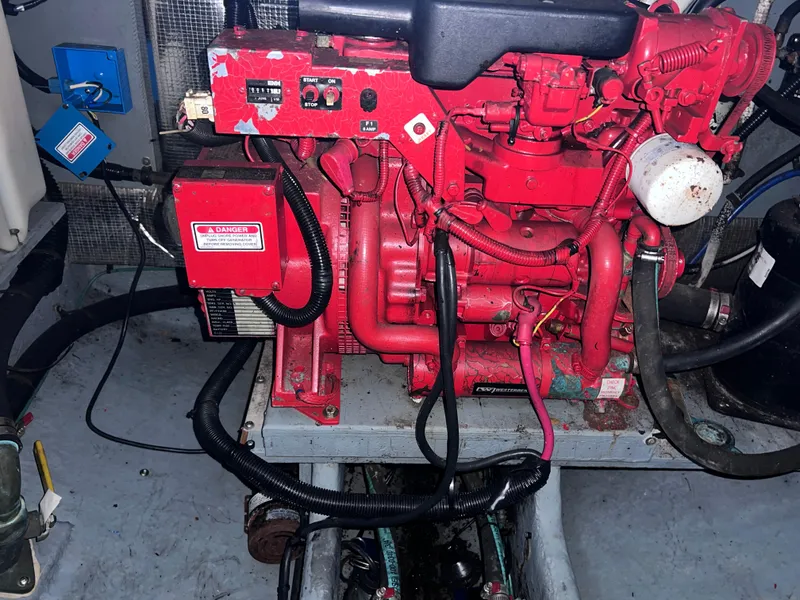 Slide: The Image of Engine compartment of a 2000 Sea Ray 290 Amberjack boat, featuring a red engine. - 25