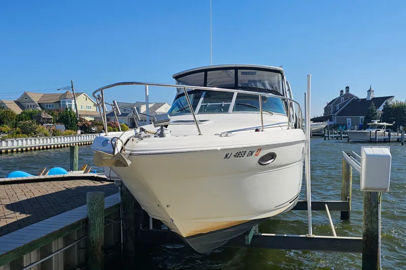 Slide: The Image of 2000 Sea Ray 290 Amberjack boat docked at a marina on a sunny day. - 5