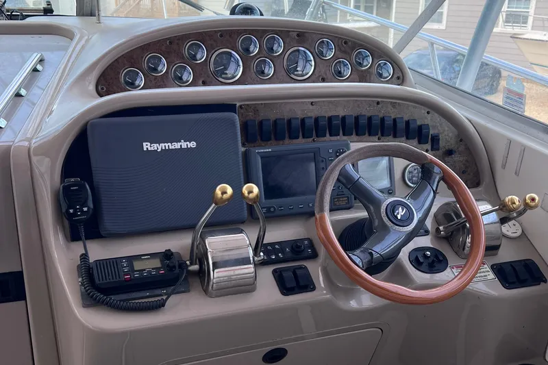 Slide: The Image of Control panel of 2000 Sea Ray 290 Amberjack with Raymarine navigation system and steering wheel. - 8