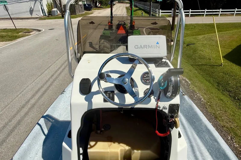 Slide: The Image of Boat console with Garmin GPS, steering wheel, and controls on a Destiny 190 TV, 2004 model. - 10