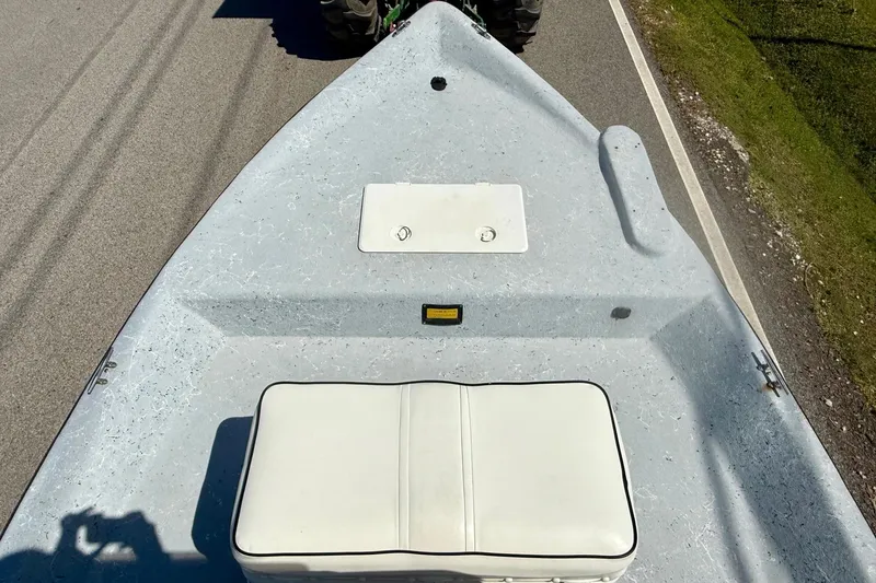 Slide: The Image of Bow view of a 2004 Destiny 190 TV boat on a road, featuring a white seat. - 12