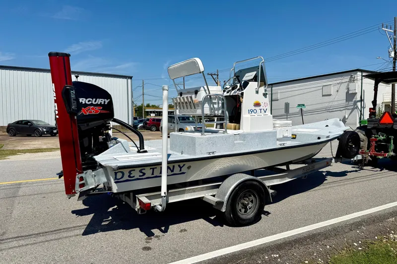 Slide: The Image of 2004 Destiny 190 TV boat on trailer with Mercury engine, parked on street. - 4