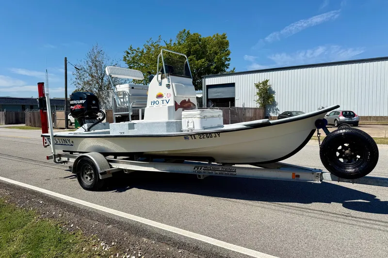 Slide: The Image of Boat on trailer, Destiny 190 TV 2004 model, parked on street under clear sky. - 5