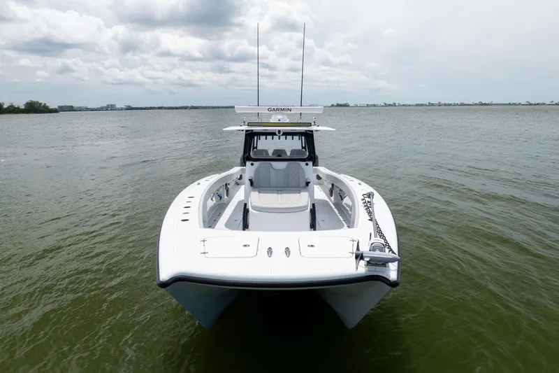 Slide: The Image of 2025 Freeman 42 LR boat on calm water, front view, overcast sky. - 10
