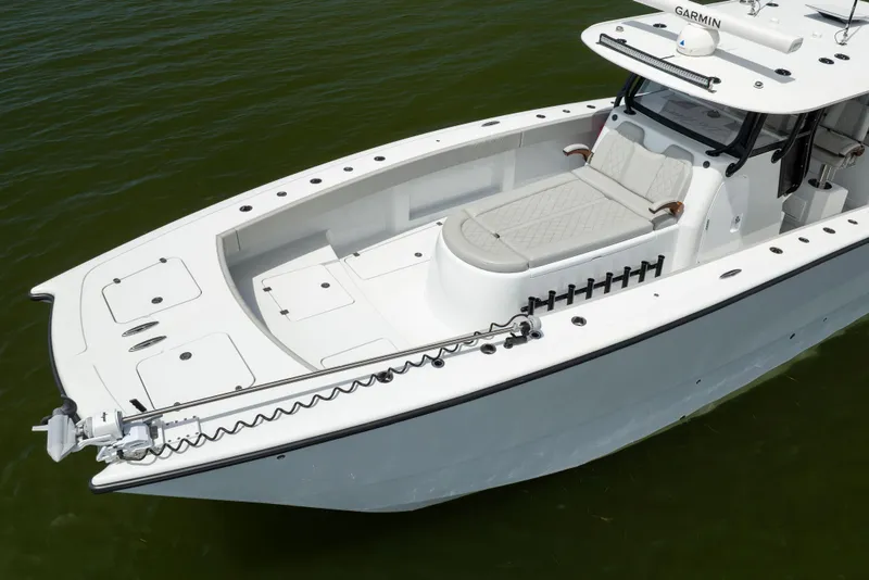 Slide: The Image of 2025 Freeman 42 LR boat with sleek design and spacious deck on water. - 12