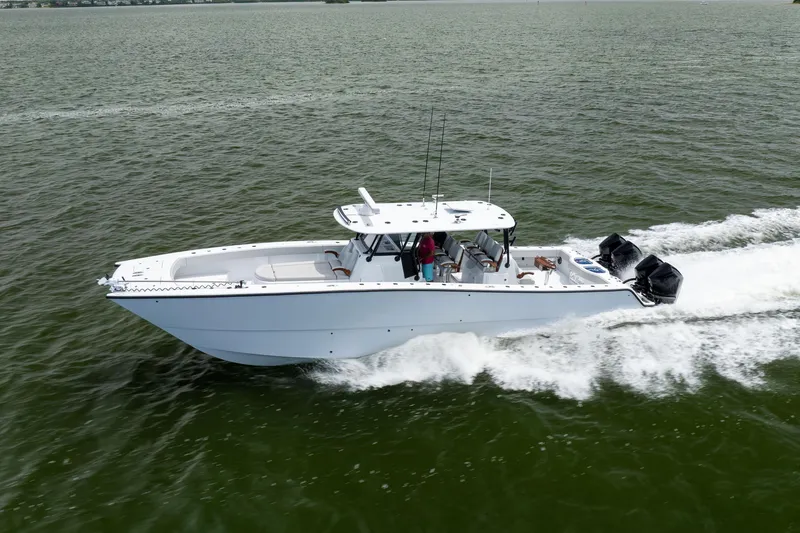 Slide: The Image of 2025 Freeman 42 LR boat cruising on open water, showcasing sleek design and powerful engines. - 13