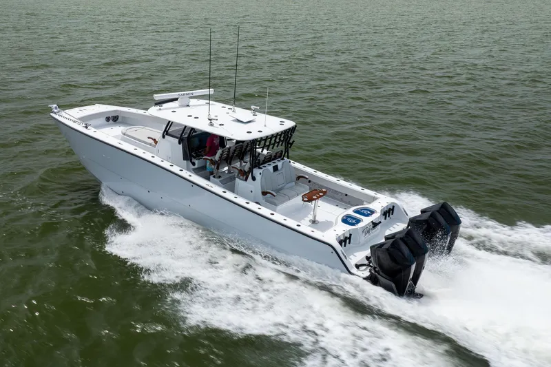 Slide: The Image of 2025 Freeman 42 LR boat cruising on open water, showcasing powerful engines. - 14