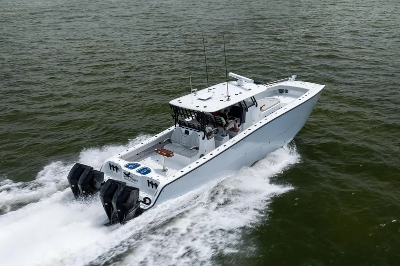 Slide: The Image of 2025 Freeman 42 LR boat cruising on open water, showcasing sleek design and powerful engines. - 15