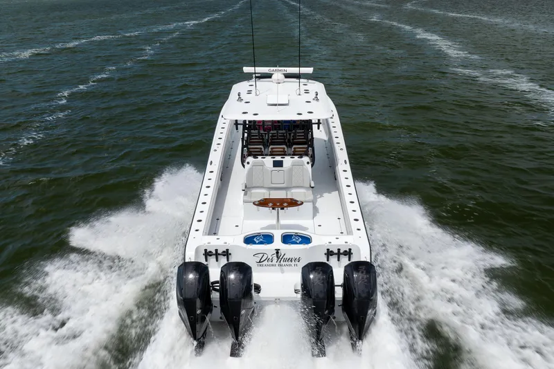 Slide: The Image of 2025 Freeman 42 LR boat cruising on open water with powerful engines. - 17