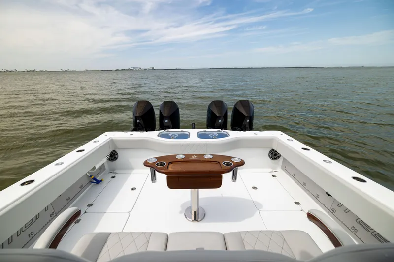 Slide: The Image of 2025 Freeman 42 LR boat with quad engines on open water, featuring a spacious deck. - 20