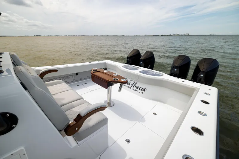 Slide: The Image of Freeman 42 LR 2025 boat with seating and four engines on open water. - 21