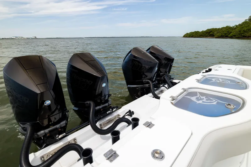 Slide: The Image of Freeman 42 LR 2025 boat with powerful outboard motors on a calm waterway. - 26