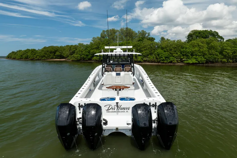 Slide: The Image of 2025 Freeman 42 LR boat with four engines on a scenic waterway. - 3