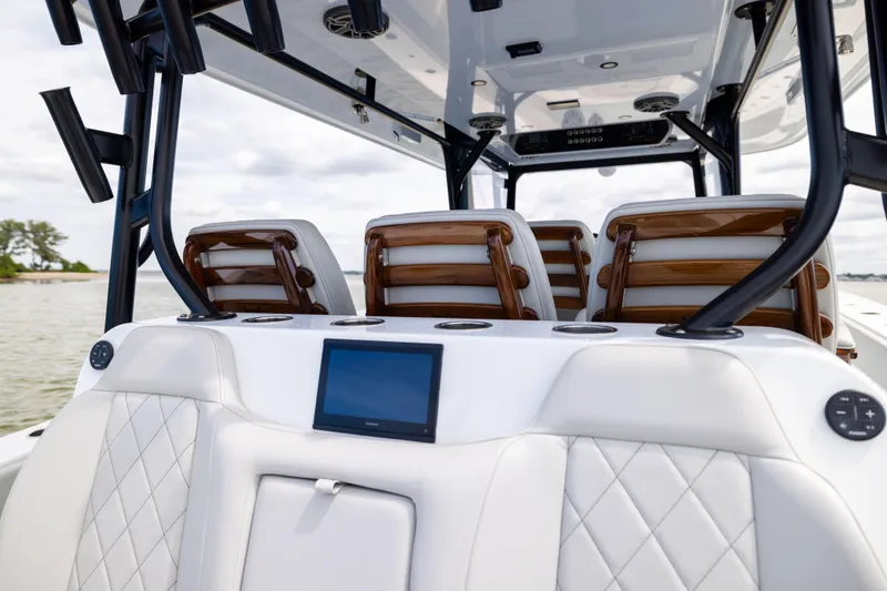 Slide: The Image of 2025 Freeman 42 LR boat interior with luxurious seating and modern dashboard on the water. - 31