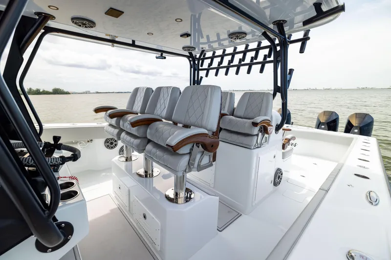 Slide: The Image of Luxury seating on 2025 Freeman 42 LR boat, featuring elegant design and ocean backdrop. - 46