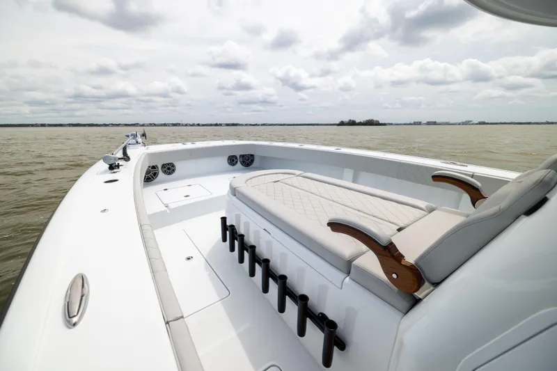 Slide: The Image of Luxury Freeman 42 LR boat interior, 2025 model, featuring elegant seating and rod holders on open water. - 50