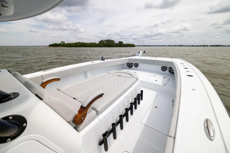 Slide: The Image of 2025 Freeman 42 LR boat interior with seating, rod holders, and ocean view. - 51