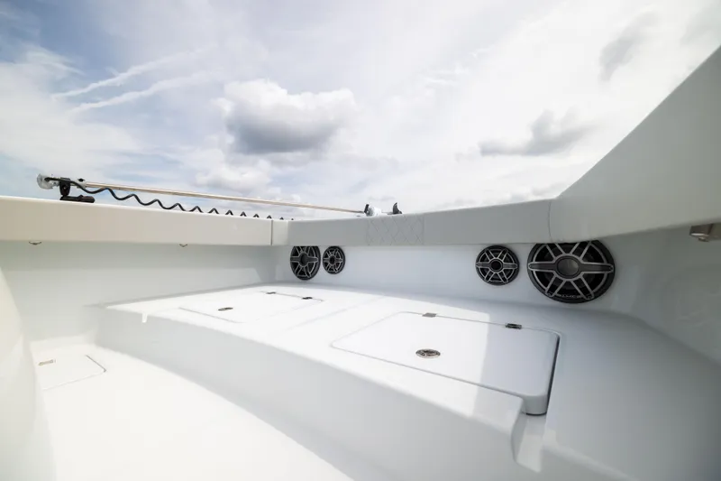 Slide: The Image of 2025 Freeman 42 LR boat interior with speakers and storage compartments under a cloudy sky. - 53