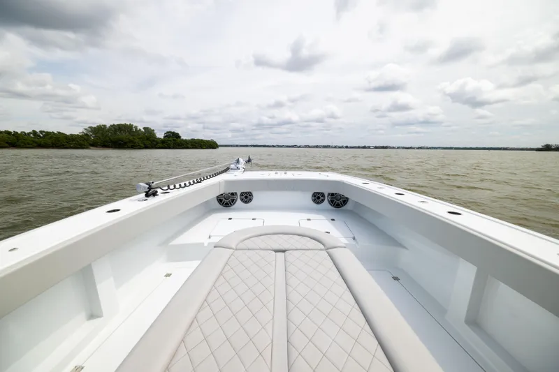 Slide: The Image of Bow view of 2025 Freeman 42 LR boat on open water under cloudy sky. - 54