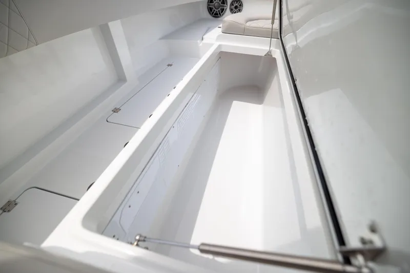 Slide: The Image of Spacious storage compartment on 2025 Freeman 42 LR boat, featuring sleek white interior design. - 62