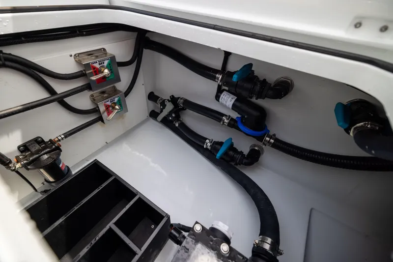 Slide: The Image of Engine compartment of 2025 Freeman 42 LR boat with hoses and control switches. - 65