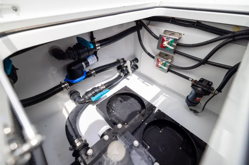 Slide: The Image of Freeman 42 LR 2025 boat plumbing system with valves and hoses in a compartment. - 66