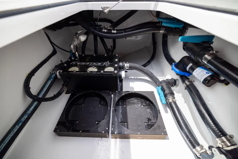 Slide: The Image of Engine compartment of 2025 Freeman 42 LR boat with visible hoses and components. - 67