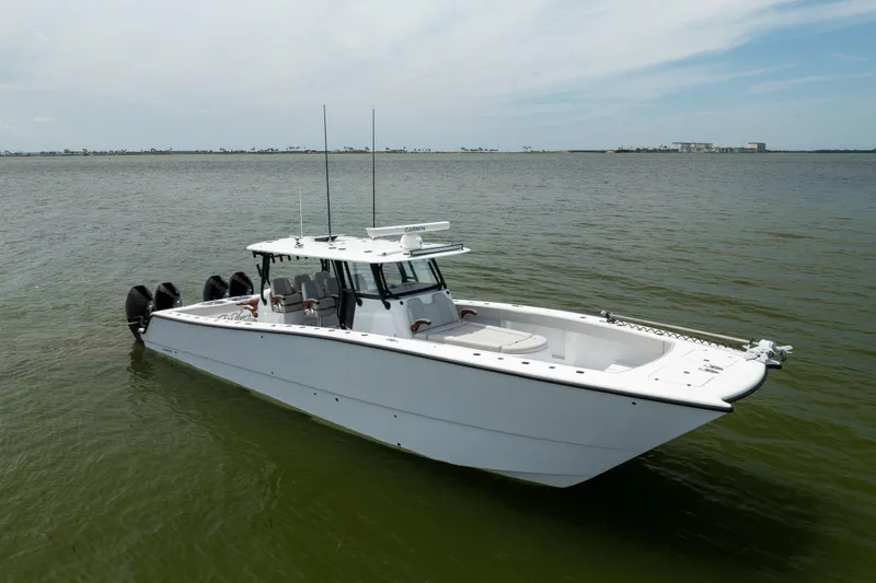 Slide: The Image of 2025 Freeman 42 LR boat on calm water, showcasing sleek design and powerful engines. - 9