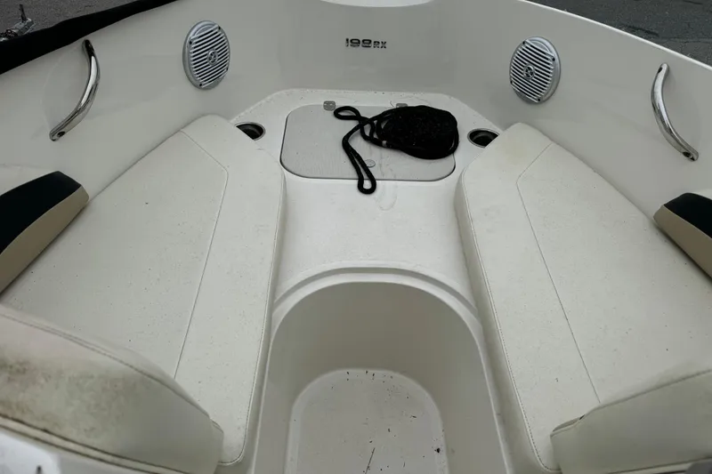Slide: The Image of Interior of a 2016 Stingray 198 RX boat with seating and speakers. - 12
