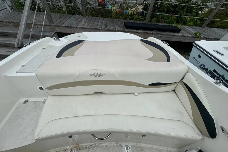 Slide: The Image of 2016 Stingray 198 RX boat interior with cushioned seating and stylish design. - 5