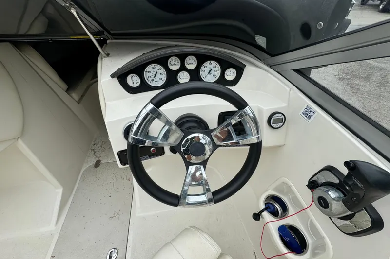 Slide: The Image of 2016 Stingray 198 RX boat dashboard with steering wheel and gauges. - 6