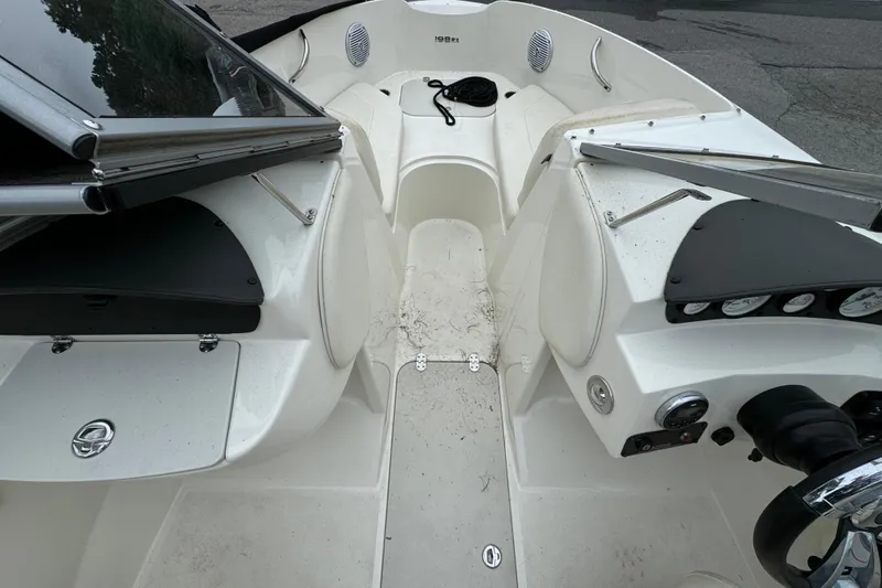 Slide: The Image of 2016 Stingray 198 RX boat interior with dashboard and seating area. - 8