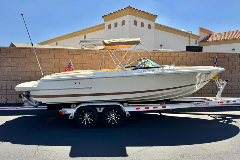 The Image of 2013 Chris-Craft Launch 22 boat on trailer, parked outdoors, sunny day. - 0