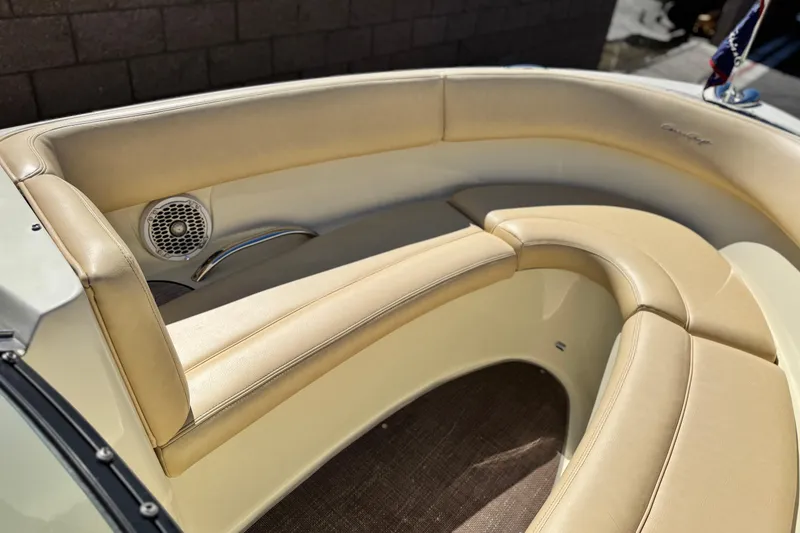 Slide: The Image of 2013 Chris-Craft Launch 22 boat interior with beige leather seating and speaker. - 11