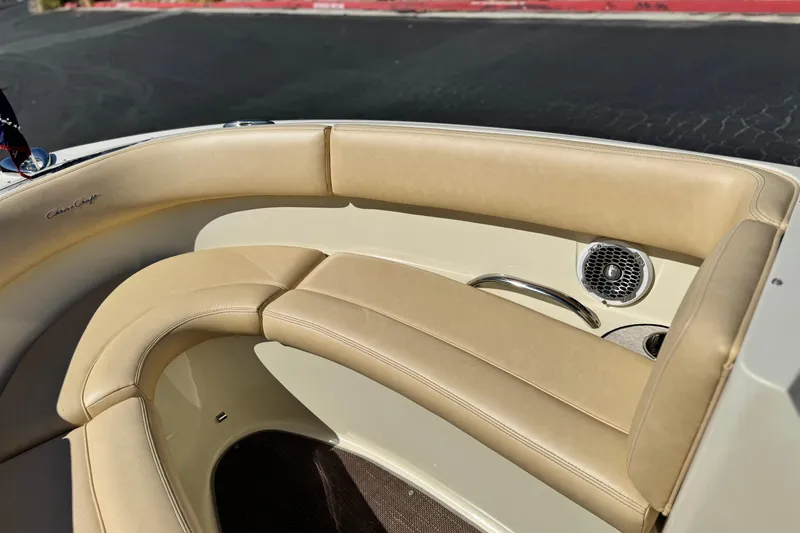 Slide: The Image of 2013 Chris-Craft Launch 22 boat interior with beige leather seating and speaker detail. - 12