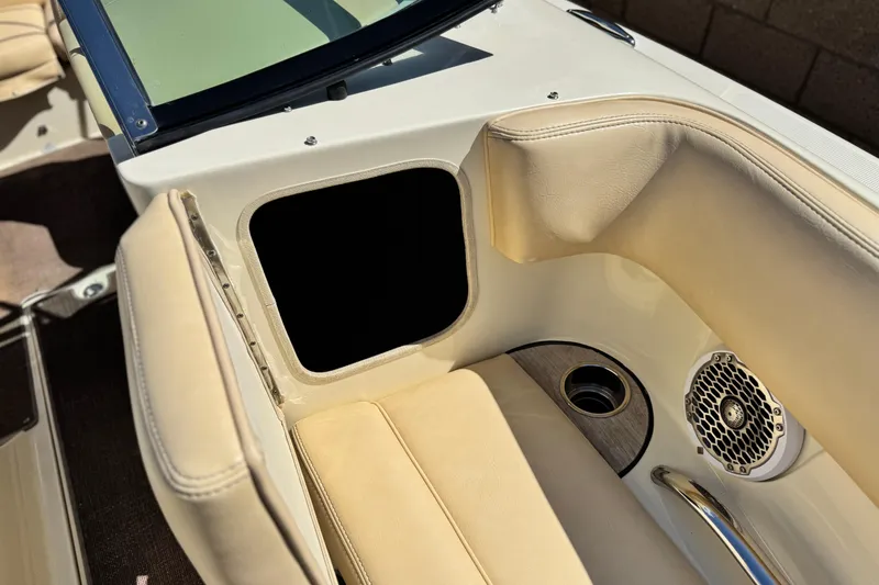 Slide: The Image of 2013 Chris-Craft Launch 22 interior with beige seating, speaker, and cup holder. - 13
