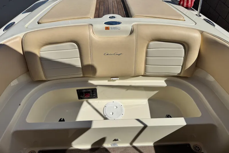Slide: The Image of 2013 Chris-Craft Launch 22 boat interior with beige seating and storage compartment. - 18