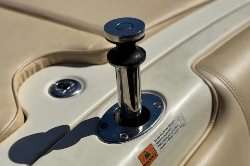 Slide: The Image of 2013 Chris-Craft Launch 22 boat detail, featuring a chrome pop-up cleat on beige upholstery. - 19