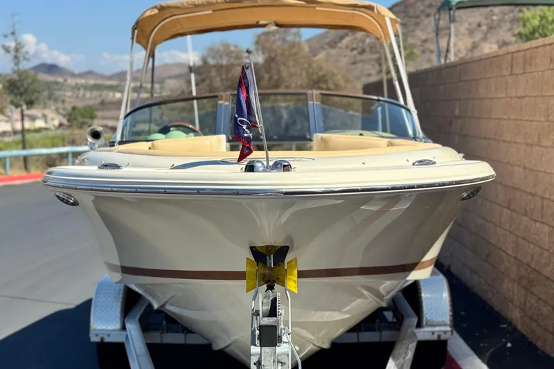 Slide: The Image of 2013 Chris-Craft Launch 22 boat on trailer, parked outdoors. - 2