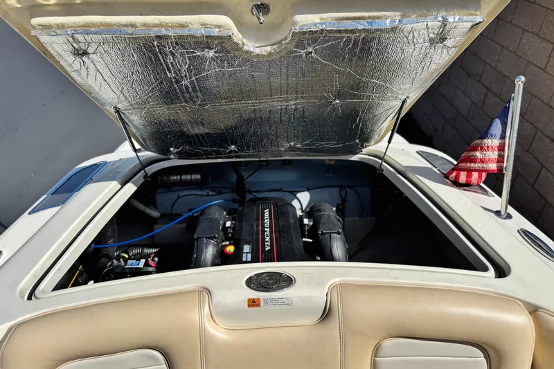 Slide: The Image of 2013 Chris-Craft Launch 22 boat engine compartment with Volvo Penta engine and American flag. - 20