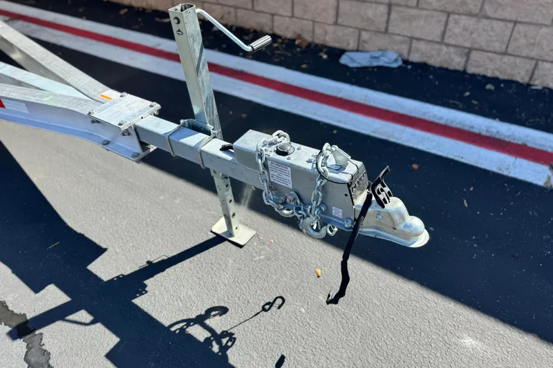 Slide: The Image of Trailer hitch for 2013 Chris-Craft Launch 22 boat on asphalt surface. - 28