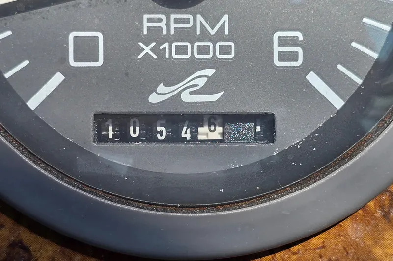 Slide: The Image of RPM gauge of 1995 Sea Ray 330 Sundancer showing 1054.6 hours. - 11