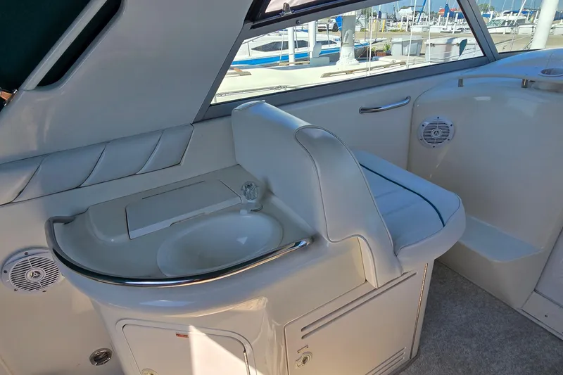 Slide: The Image of Interior of 1995 Sea Ray 330 Sundancer boat with sink and seating area. - 14
