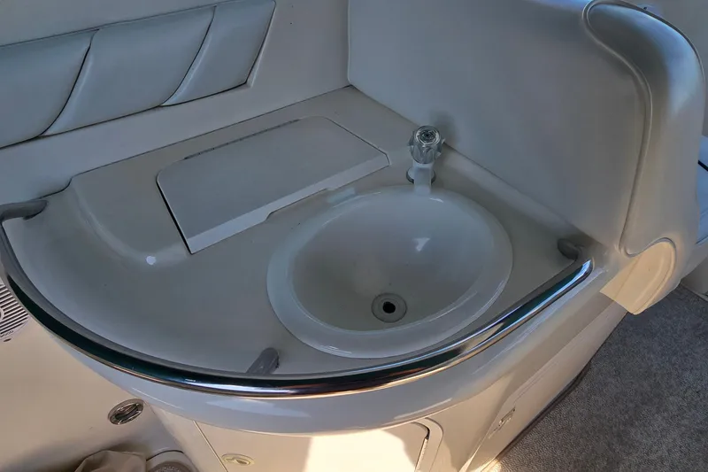 Slide: The Image of 1995 Sea Ray 330 Sundancer boat sink with faucet and countertop. - 16