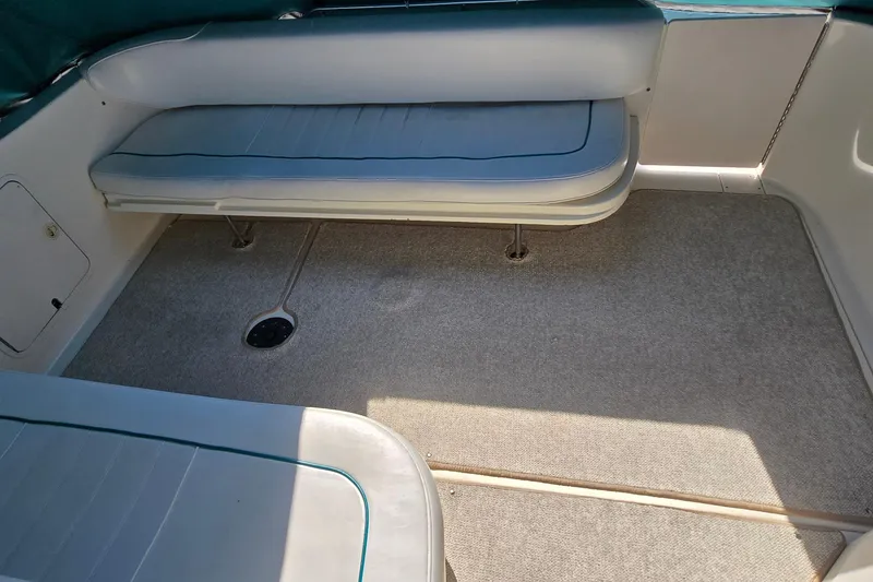 Slide: The Image of 1995 Sea Ray 330 Sundancer interior with cushioned seating and carpeted flooring. - 19