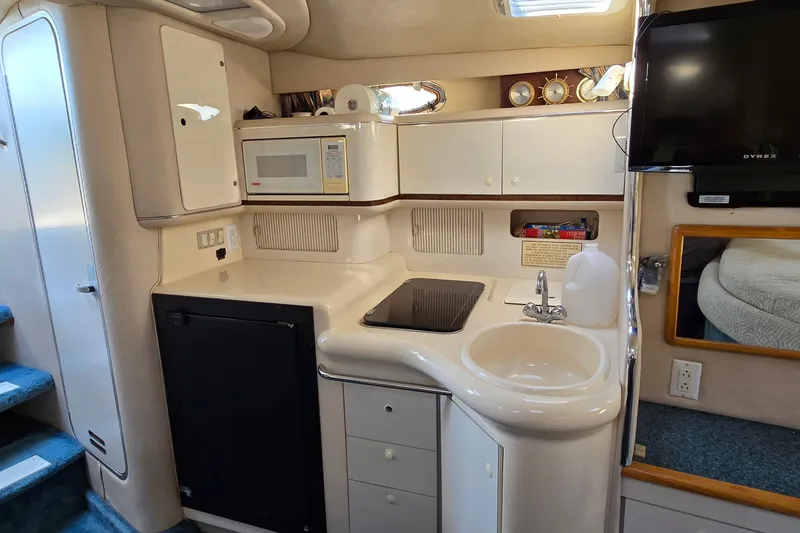 Slide: The Image of Interior of 1995 Sea Ray 330 Sundancer with kitchenette, microwave, and sink. - 22