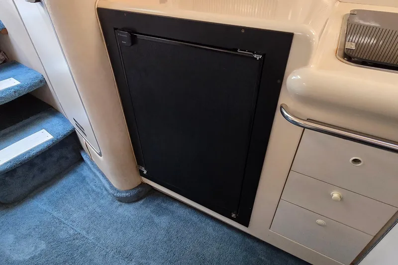 Slide: The Image of Interior of 1995 Sea Ray 330 Sundancer with carpeted stairs and cabinetry. - 24