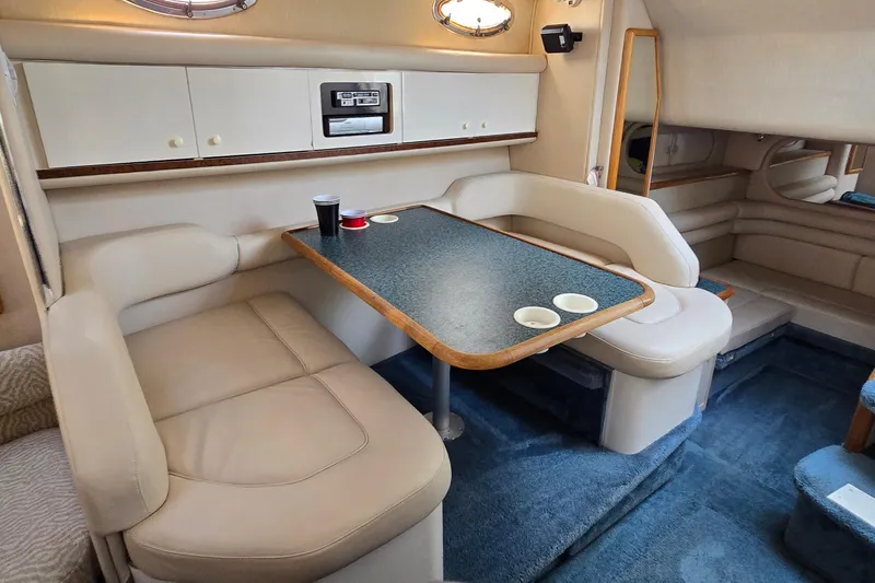 Slide: The Image of Interior of 1995 Sea Ray 330 Sundancer with cozy seating and dining area. - 26