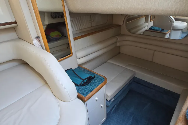 Slide: The Image of Interior of 1995 Sea Ray 330 Sundancer with beige seating and blue carpet. - 28